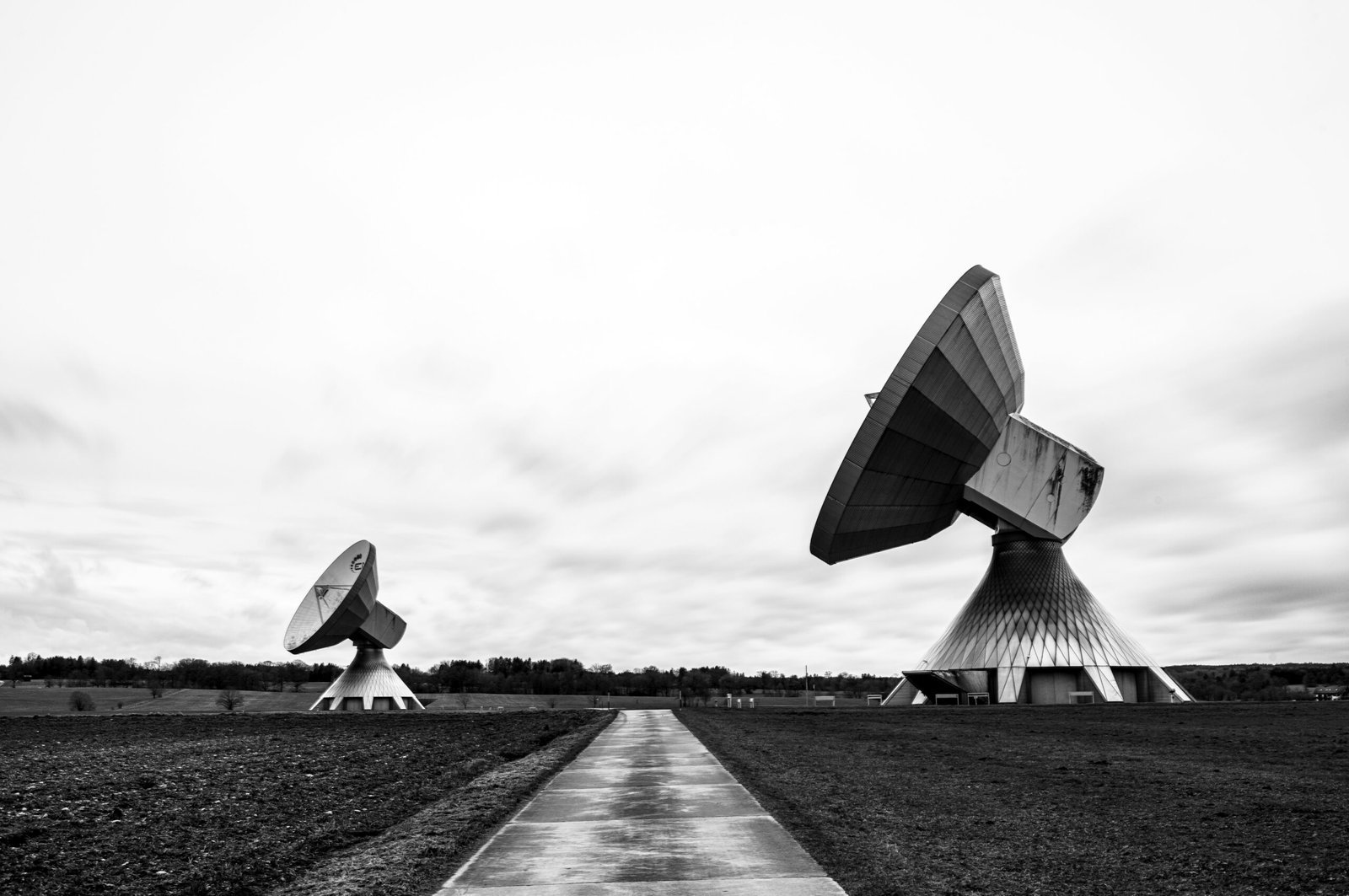 a black and white photo of two satellite dishes